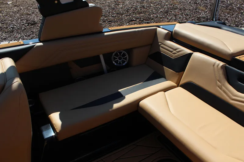 Slide: The Image of 2025 ATX Surf Boats 22 Type-S interior with tan seating and speaker system. - 10