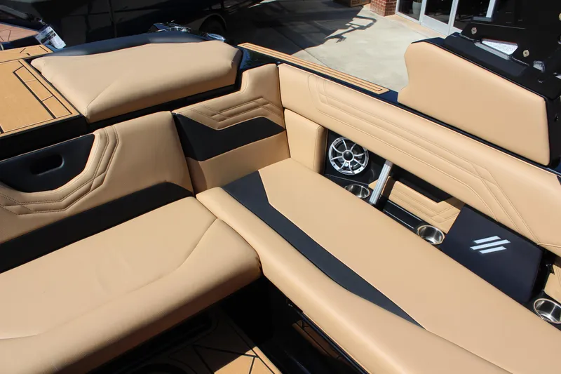 Slide: The Image of 2025 ATX Surf Boats 22 Type-S interior with tan and black seating, featuring built-in speakers. - 11