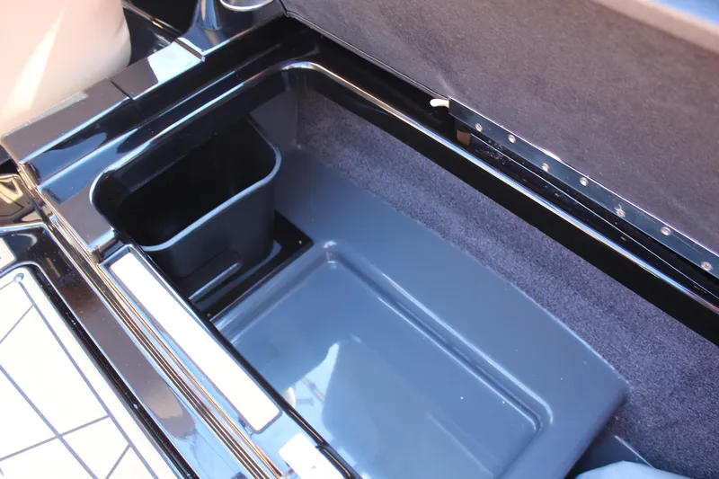 Slide: The Image of 2025 ATX Surf Boats 22 Type-S storage compartment with sleek black and gray interior design. - 13