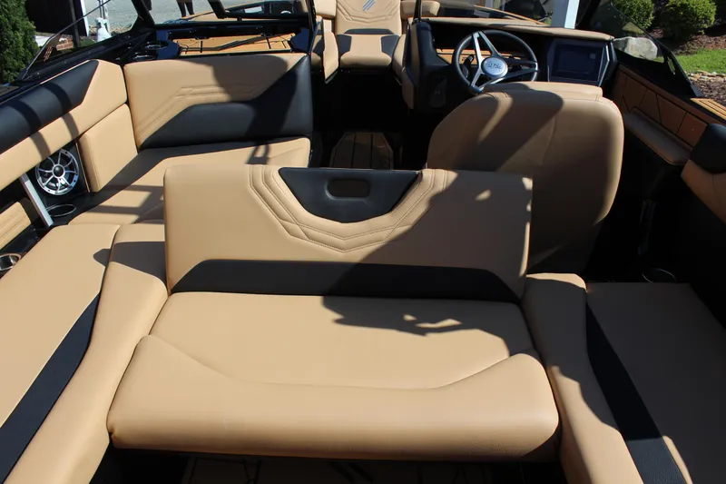 Slide: The Image of 2025 ATX Surf Boats 22 Type-S interior with tan seating and modern dashboard. - 14