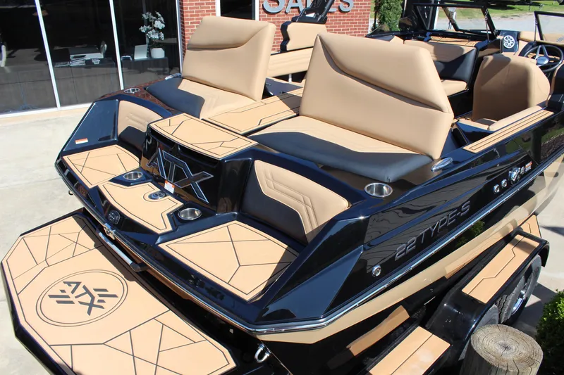 Slide: The Image of 2025 ATX Surf Boats 22 Type-S with tan seating and sleek black design. - 7