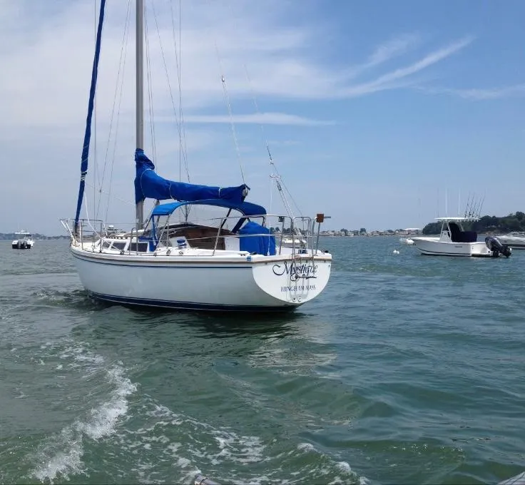 Slide: The Image of 1985 Catalina 30 sailboat on calm water under a clear blue sky. - 1