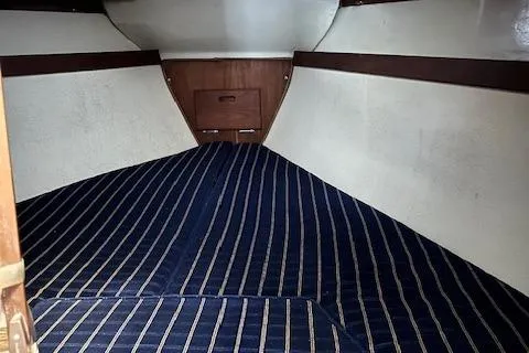 Slide: The Image of Interior cabin of a 1985 Catalina 30 sailboat with striped bedding. - 4