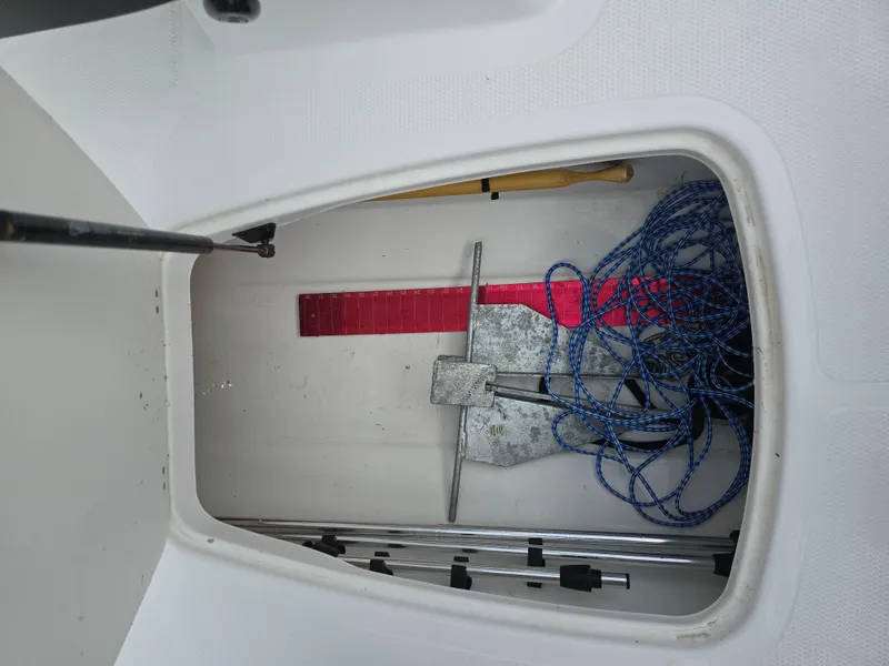 Slide: The Image of Storage compartment of 2021 Tahoe 450 TF boat with anchor and ropes. - 13