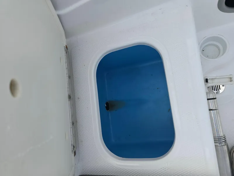 Slide: The Image of Livewell compartment in a 2021 Tahoe 450 TF boat, featuring a blue interior. - 16