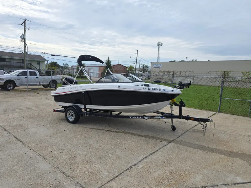Slide: The Image of 2021 Tahoe 450 TF boat on trailer in parking lot, overcast sky. - 6