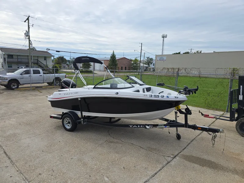 Slide: The Image of 2021 Tahoe 450 TF boat on trailer in parking lot. - 8