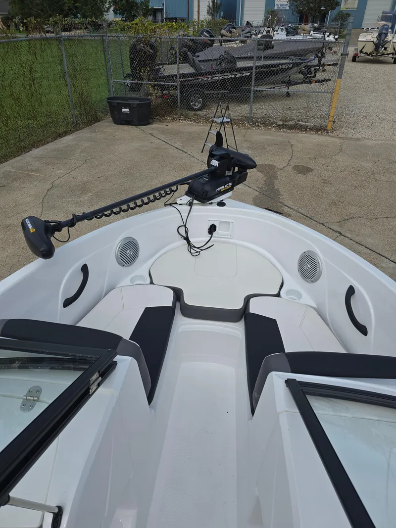 Slide: The Image of 2021 Tahoe 450 TF boat with trolling motor, docked on concrete surface. - 9