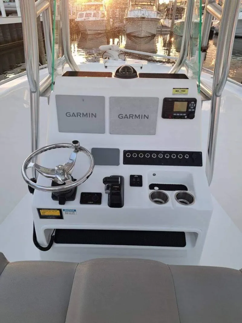 Slide: The Image of 2020 Cape Horn 22 OS boat console with Garmin navigation, steering wheel, and controls. - 1