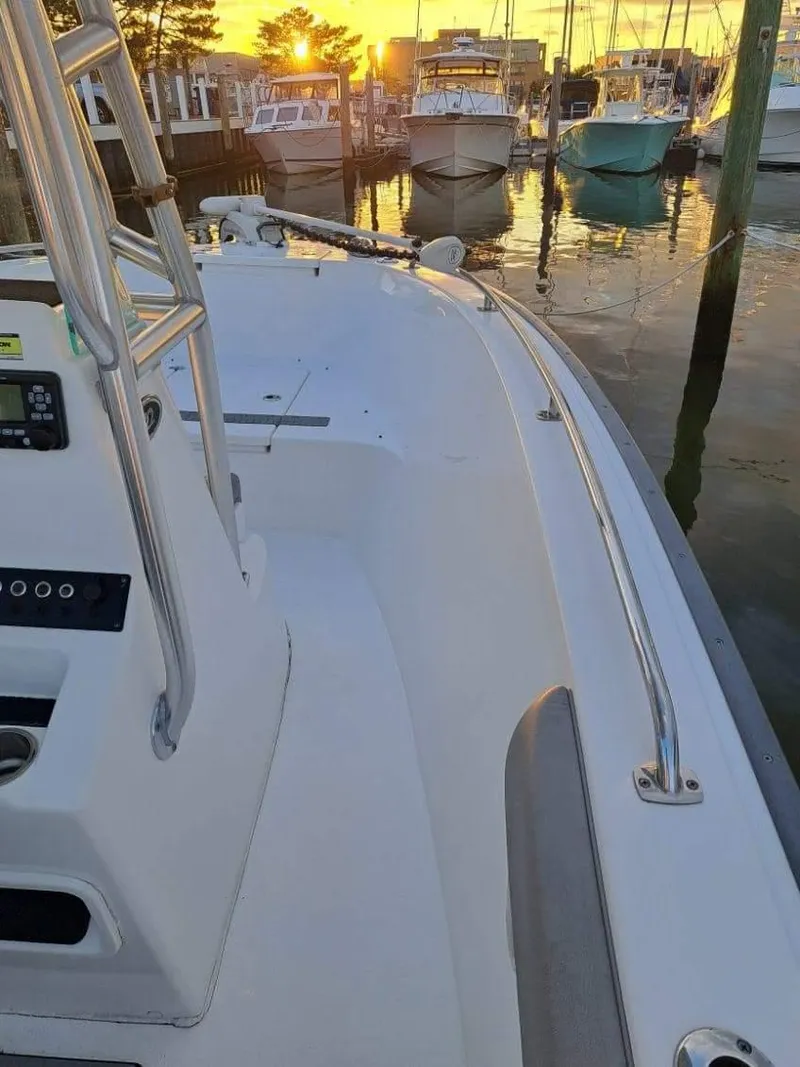 Slide: The Image of 2020 Cape Horn 22 OS boat docked at sunset with other boats in the background. - 2