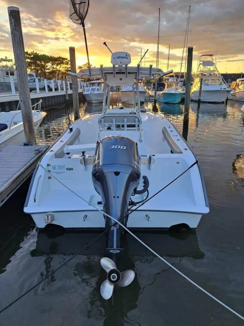Slide: The Image of 2020 Cape Horn 22 OS boat docked at sunset, featuring a powerful outboard motor. - 3
