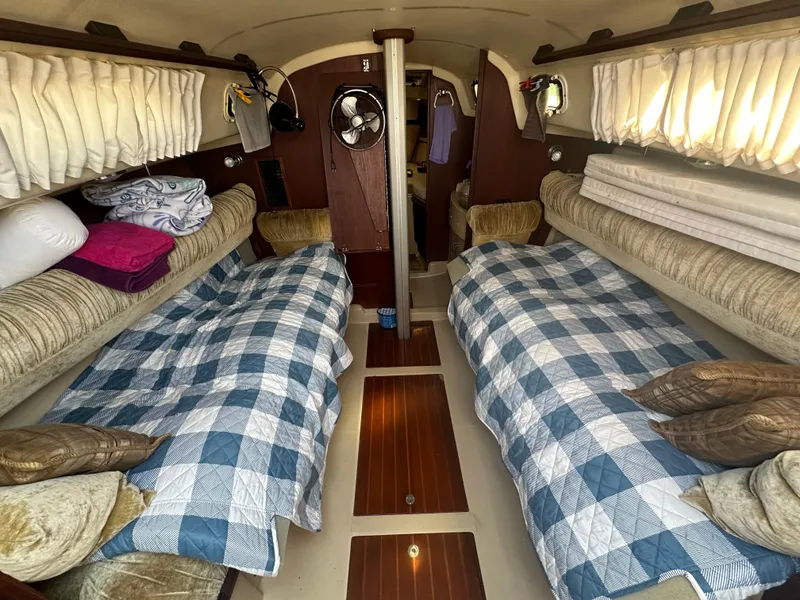 Slide: The Image of Interior of 1983 O'Day 28 sailboat with twin beds and cozy decor. - 12
