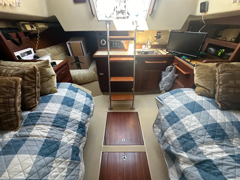 Slide: The Image of Cozy 1983 O'Day 28 sailboat cabin with twin beds, wood accents, and nautical decor. - 13