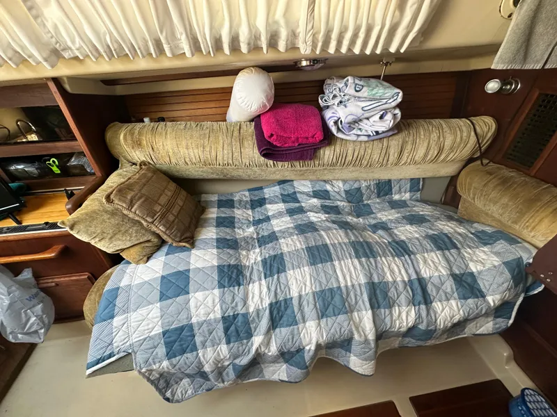 Slide: The Image of Cozy cabin interior of 1983 O'Day 28 sailboat with plaid bedding and cushions. - 16