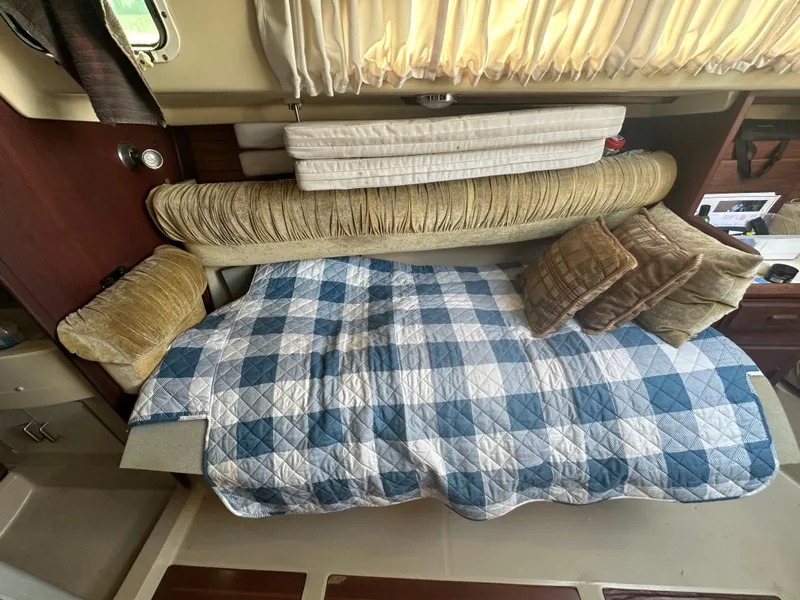 Slide: The Image of Cozy cabin interior of 1983 O'Day 28 sailboat with blue checkered bedding. - 18