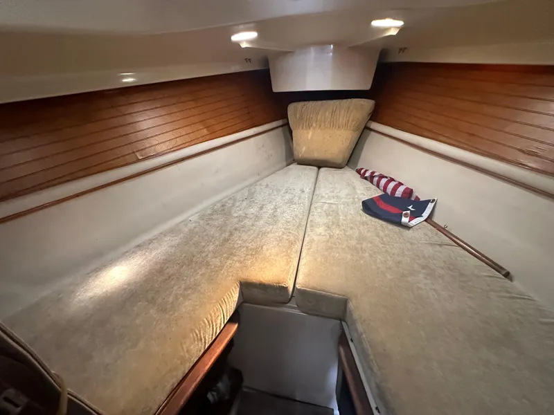 Slide: The Image of Interior cabin of a 1983 O'Day 28 sailboat with cozy bedding and wooden accents. - 20