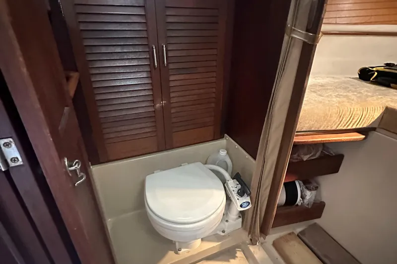Slide: The Image of 1983 O'Day 28 sailboat bathroom with toilet and wooden cabinets. - 22