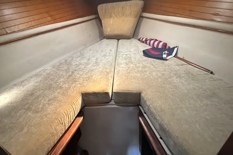 Slide: The Image of Interior cabin of 1983 O'Day 28 sailboat with beige cushions and wooden accents. - 24