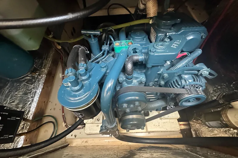 Slide: The Image of 1983 O'Day 28 sailboat engine in a compact compartment. - 26