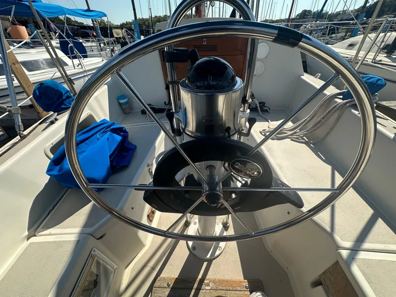 Slide: The Image of 1983 O'Day 28 sailboat cockpit with steering wheel and nautical equipment. - 6