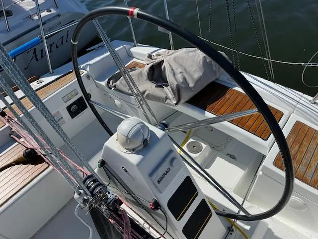 Slide: The Image of 2007 Beneteau First 36.7 sailboat cockpit with steering wheel and wooden seating. - 15