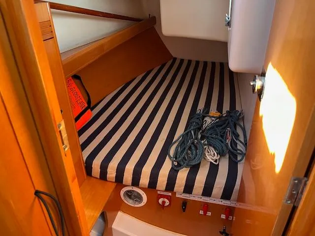 Slide: The Image of Cozy cabin interior of 2007 Beneteau First 36.7 with striped bedding and nautical ropes. - 23