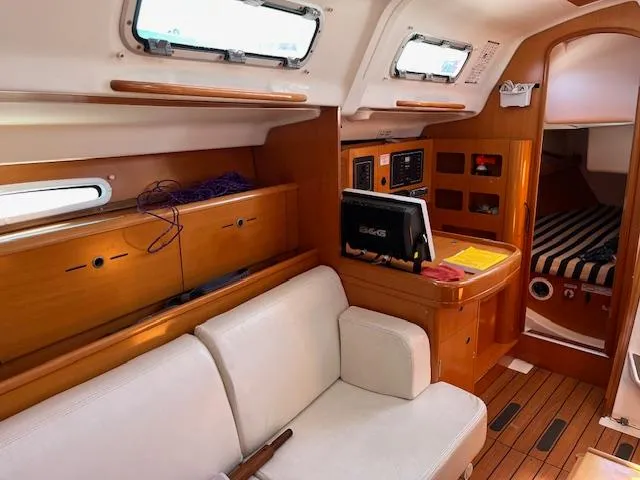 Slide: The Image of Interior of 2007 Beneteau First 36.7 sailboat with wood finish and seating area. - 26
