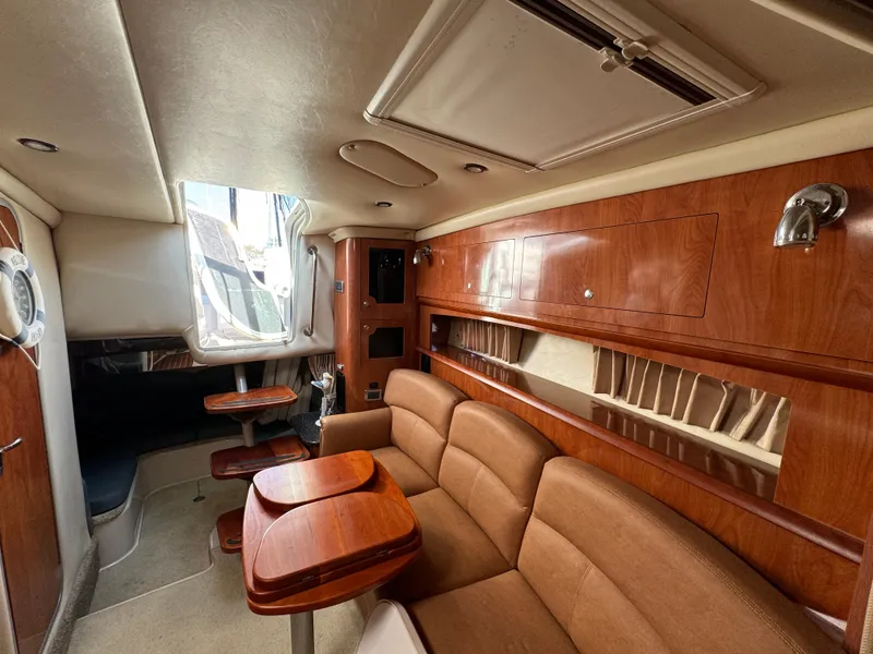 Slide: The Image of Interior of 2007 Four Winns 318 Vista boat with wood paneling and seating area. - 13