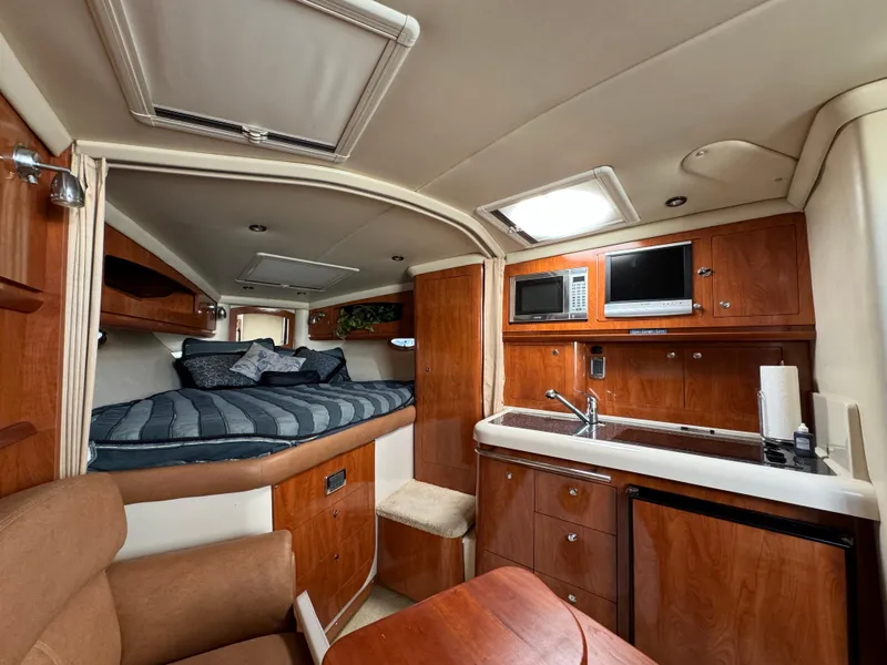 Slide: The Image of Interior of 2007 Four Winns 318 Vista yacht with kitchenette and cozy sleeping area. - 15