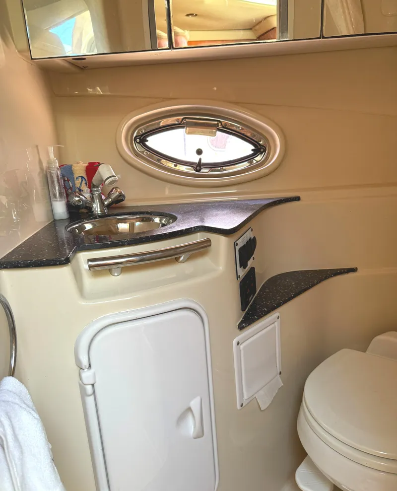 Slide: The Image of 2007 Four Winns 318 Vista boat bathroom with sink, mirror, and toilet. - 20