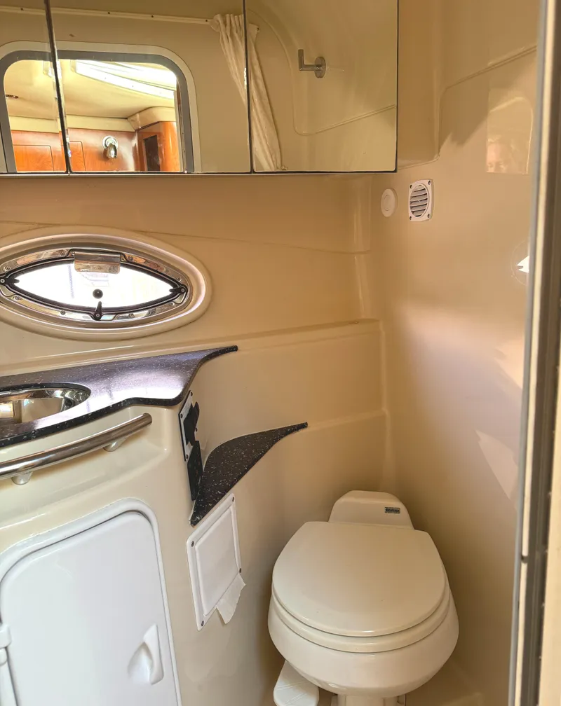 Slide: The Image of 2007 Four Winns 318 Vista boat bathroom with sink, toilet, and mirrored cabinet. - 21