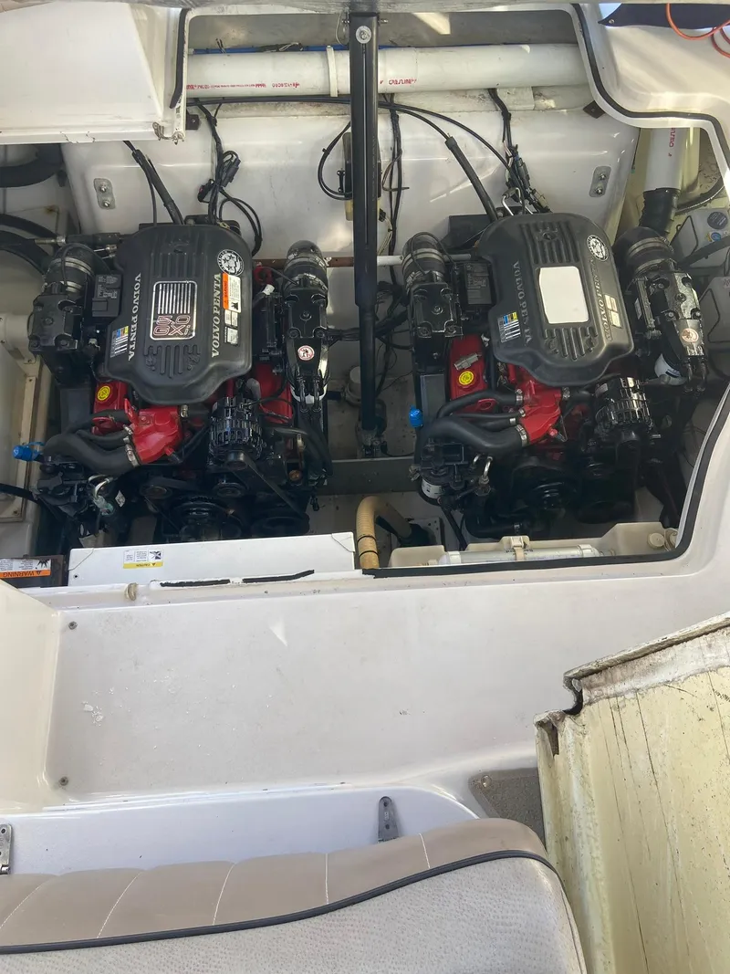 Slide: The Image of Engine compartment of a 2007 Four Winns 318 Vista boat, featuring dual engines. - 24