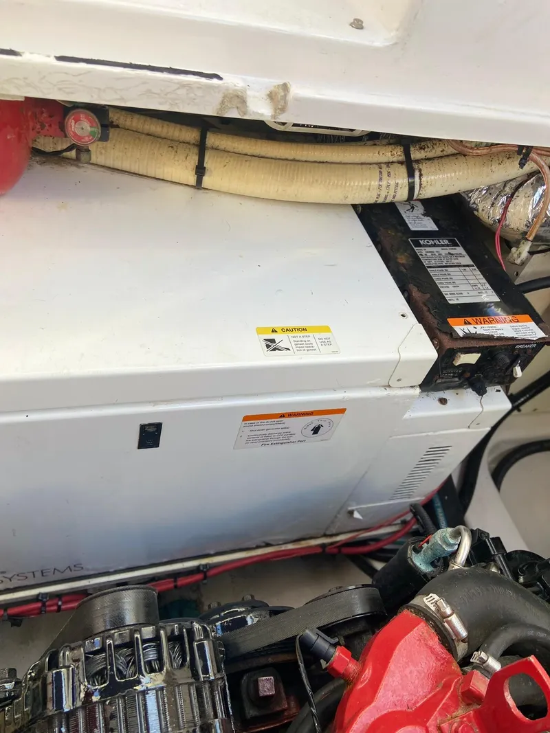 Slide: The Image of Engine compartment of 2007 Four Winns 318 Vista boat, showing mechanical components and wiring. - 27