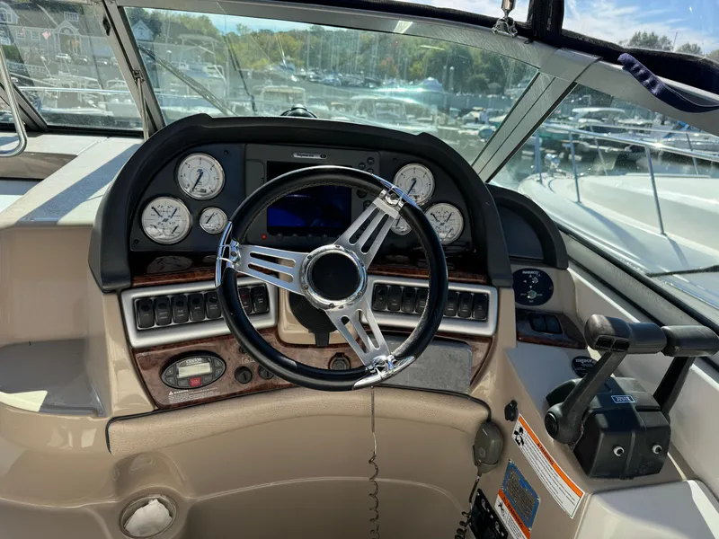 Slide: The Image of 2007 Four Winns 318 Vista boat dashboard with steering wheel and gauges. - 3