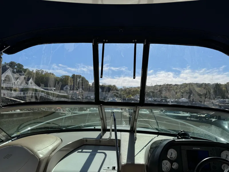 Slide: The Image of Interior view of 2007 Four Winns 318 Vista boat, overlooking marina and houses. - 4