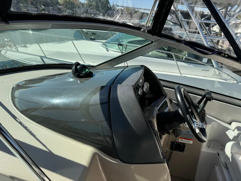 Slide: The Image of 2007 Four Winns 318 Vista boat cockpit with steering wheel and dashboard controls. - 5