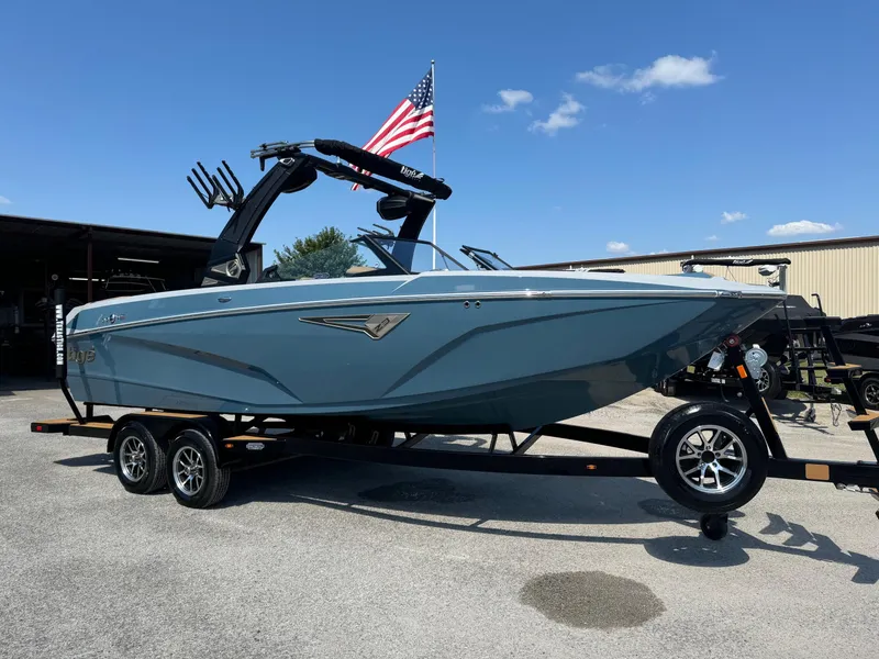 The Image of 2025 Tigé Z3 boat on trailer with American flag, under clear blue sky. - 0