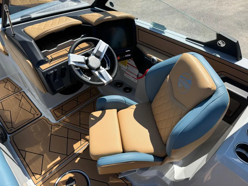 Slide: The Image of 2025 Tigé Z3 boat interior with tan and blue seating, modern steering wheel, and dashboard. - 11