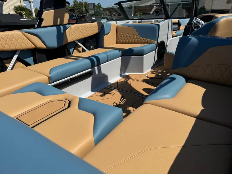 Slide: The Image of 2025 Tigé Z3 boat interior with tan and blue seating, showcasing luxury design and comfort. - 6