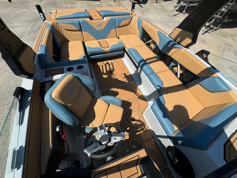 Slide: The Image of 2025 Tigé Z3 boat interior with tan and blue seating, featuring a modern steering console. - 8
