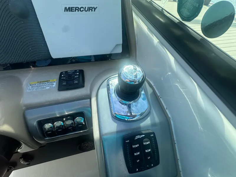 Slide: The Image of 2015 Formula 310 Bowrider control panel with Mercury joystick and switches. - 11