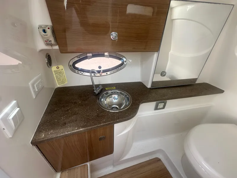 Slide: The Image of 2015 Formula 310 Bowrider bathroom with sink, countertop, and storage cabinets. - 19