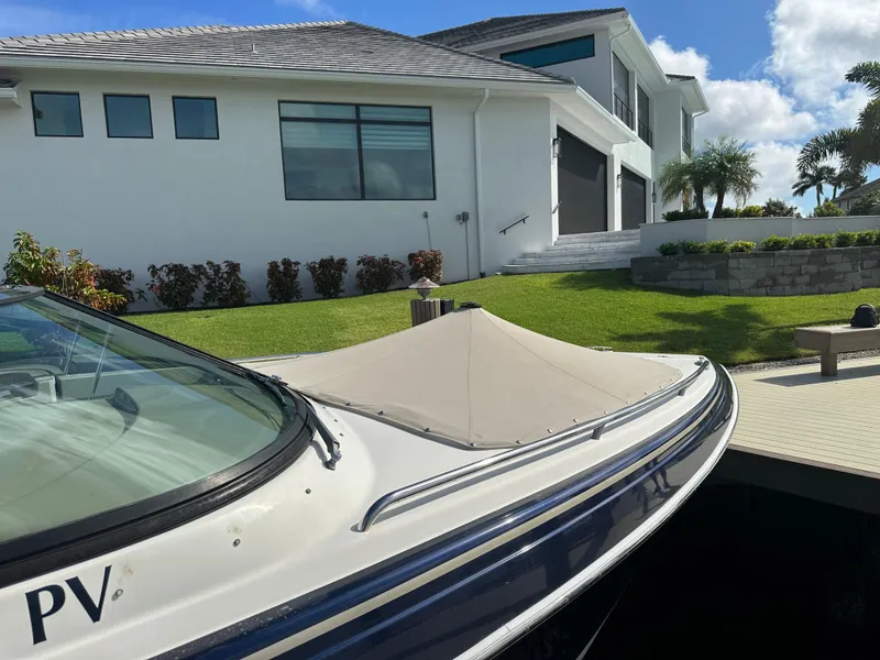 Slide: The Image of 2015 Formula 310 Bowrider docked near modern house, sunny day. - 23