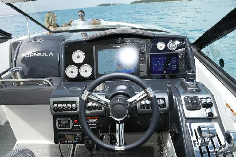 Slide: The Image of 2025 Formula 350 CBR boat dashboard with advanced navigation system on open water. - 12