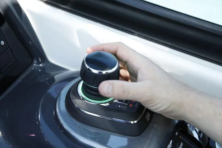 Slide: The Image of Hand operating joystick on 2025 Formula 350 CBR boat control panel. - 14