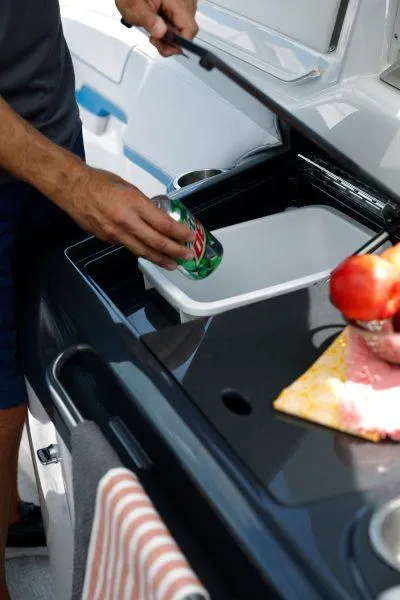 Slide: The Image of Man placing drink in cooler on 2025 Formula 350 CBR boat. - 18
