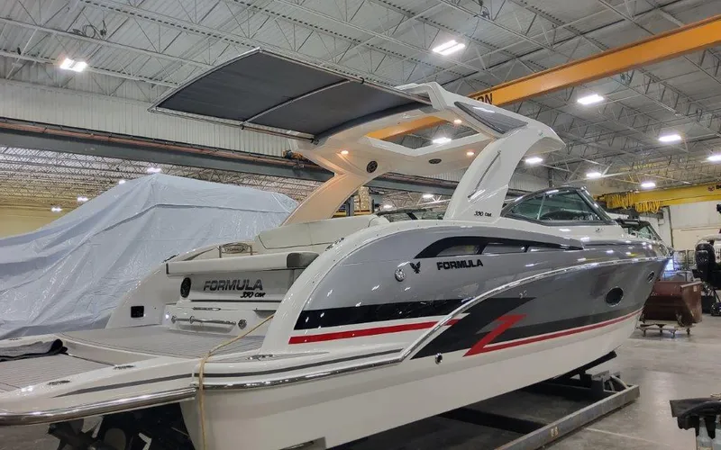 Slide: The Image of 2025 Formula 350 CBR boat in a showroom, showcasing sleek design and modern features. - 2