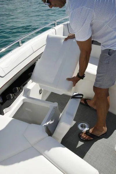 Slide: The Image of Man adjusting seat on 2025 Formula 350 CBR boat, showcasing storage compartment. - 20