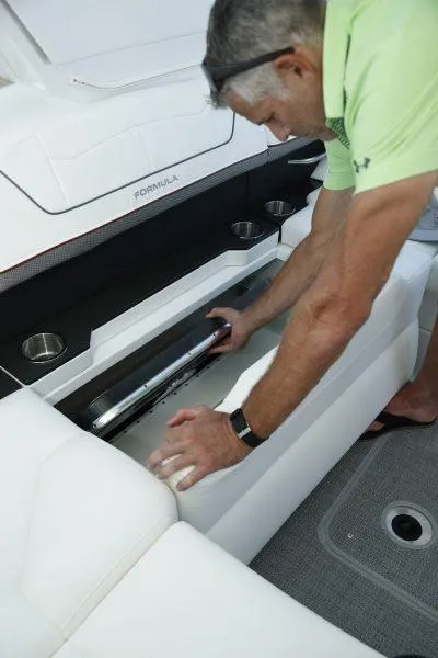 Slide: The Image of Man accessing storage compartment on 2025 Formula 350 CBR boat. - 24