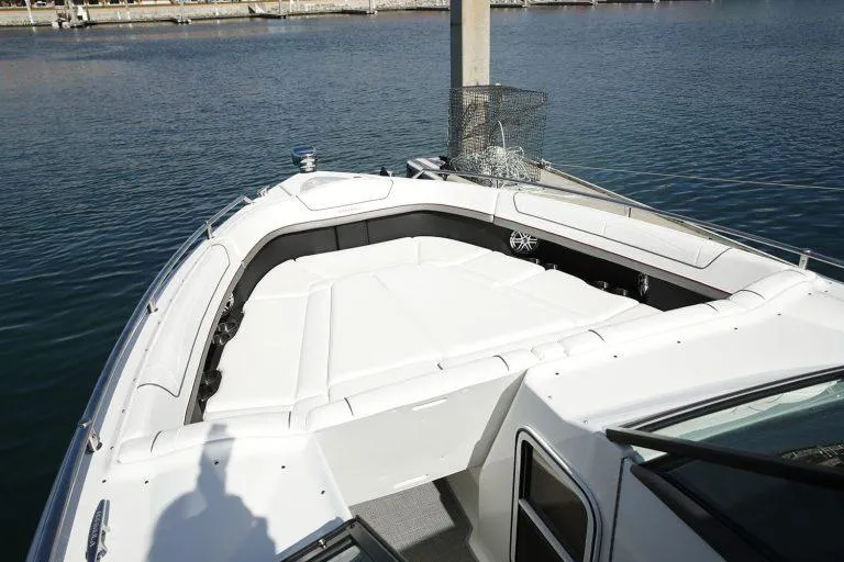 Slide: The Image of 2025 Formula 350 CBR boat bow with seating, docked on calm water. - 36